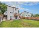 A spacious backyard with lush green grass, a wooden fence, and two story home at 4710 N Foxtail Dr, Castle Rock, CO 80109
