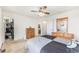 Bright bedroom with an organized walk-in closet, dresser and a ceiling fan at 4710 N Foxtail Dr, Castle Rock, CO 80109