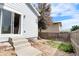 Well-maintained backyard featuring a sliding glass door, rock landscaping, and a wood fence at 3678 Shadow Cir, Castle Rock, CO 80109