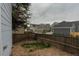 Cozy backyard featuring a gravel area, partial grass, and a wooden fence at 3678 Shadow Cir, Castle Rock, CO 80109