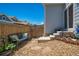 Private backyard featuring a seating area, rock accents, and convenient home access with lush green foliage at 3678 Shadow Cir, Castle Rock, CO 80109