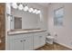 Well-lit bathroom with double sinks, granite countertops, and white cabinets at 3678 Shadow Cir, Castle Rock, CO 80109