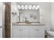 Bathroom featuring a double vanity, granite countertops, framed mirrors, and a glass-enclosed shower at 3678 Shadow Cir, Castle Rock, CO 80109