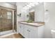 Well-lit bathroom featuring a double vanity, granite countertops, framed mirrors, and a glass-enclosed shower at 3678 Shadow Cir, Castle Rock, CO 80109