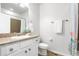 Cozy bathroom with a granite countertop vanity, decorative mirror, a shower-tub combo, and a neutral color scheme at 3678 Shadow Cir, Castle Rock, CO 80109