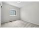 Empty bedroom featuring natural lighting, a window, neutral carpet, and a minimalist design at 3678 Shadow Cir, Castle Rock, CO 80109