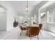 Open-concept floor plan showcases a dining area with modern chandelier and a sun-filled living space at 3678 Shadow Cir, Castle Rock, CO 80109