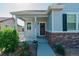 Charming home exterior with front porch, brick accents, and well-manicured landscaping at 3678 Shadow Cir, Castle Rock, CO 80109