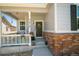 Inviting front porch with decorative touches, flowers, and a charming wreath on the front door at 3678 Shadow Cir, Castle Rock, CO 80109