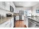 Modern kitchen featuring granite countertops, stainless steel appliances, and white cabinetry at 3678 Shadow Cir, Castle Rock, CO 80109