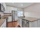 Modern kitchen features granite counters, stainless steel refrigerator, and white cabinets at 3678 Shadow Cir, Castle Rock, CO 80109