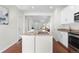 Charming kitchen island overlooking a dining area and sun-drenched living room at 3678 Shadow Cir, Castle Rock, CO 80109