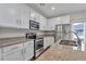 Bright kitchen features stainless steel appliances, granite countertops, and white cabinets at 3678 Shadow Cir, Castle Rock, CO 80109
