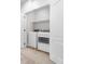 Bright laundry room featuring a full-size washer and dryer, plus built-in shelving for storage at 3678 Shadow Cir, Castle Rock, CO 80109