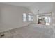 Bright and spacious living area leading to the kitchen, filled with natural light from large windows at 3678 Shadow Cir, Castle Rock, CO 80109