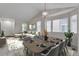 Bright living room and dining area featuring vaulted ceilings, neutral décor, and large windows at 3678 Shadow Cir, Castle Rock, CO 80109