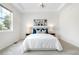 Bright bedroom features plush bedding, soft lighting, and a large window with a trey ceiling at 3678 Shadow Cir, Castle Rock, CO 80109