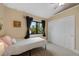 Bright bedroom features a ceiling fan, window views, and closet storage, creating a comfortable space at 23 Honey Locust, Littleton, CO 80127
