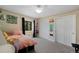 Comfortable bedroom featuring carpeted floors, ample closet space, and a sunlit window; a restful retreat at 23 Honey Locust, Littleton, CO 80127