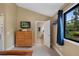 Bedroom with vaulted ceilings, dresser and TV; Bathroom is visible through doorway at 23 Honey Locust, Littleton, CO 80127