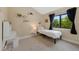 Cozy bedroom with neutral walls, window views, and charming decor; a delightful and inviting space at 23 Honey Locust, Littleton, CO 80127