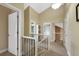 Upstairs hallway featuring white railings, neutral paint and architectural details at 23 Honey Locust, Littleton, CO 80127