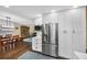 Updated kitchen featuring stainless steel appliances, white cabinets, hardwood floors, and modern fixtures at 23 Honey Locust, Littleton, CO 80127