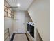 Functional laundry room equipped with modern washer and dryer, and overhead drying rack for added convenience at 23 Honey Locust, Littleton, CO 80127