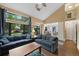 Comfortable living room featuring vaulted ceiling, skylight, large windows, and hardwood flooring at 23 Honey Locust, Littleton, CO 80127
