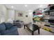 Relaxing living room with comfortable seating, open shelving, and entertainment space; perfect for unwinding at 23 Honey Locust, Littleton, CO 80127