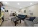 Spacious living room with comfortable sofas, a dark wood coffee table, and an adjacent office space at 23 Honey Locust, Littleton, CO 80127