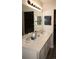 Bathroom features vanity with a white countertop and an expansive mirror and vanity lights at 2625 S Xanadu Way # E, Aurora, CO 80014