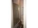 Bathroom with tile shower and glass door, toilet and cabinet at 2625 S Xanadu Way # E, Aurora, CO 80014