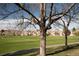 Community view with lush green lawn, walking path, and views of surrounding homes at 2625 S Xanadu Way # E, Aurora, CO 80014