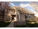 Charming two-story home with neutral siding, walkway, and lush landscaping at 2625 S Xanadu Way # E, Aurora, CO 80014