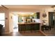 Eat-in kitchen with green cabinets, center island, breakfast bar, and stainless steel appliances at 2625 S Xanadu Way # E, Aurora, CO 80014