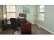 Bright home office with a large desk, comfortable seating, and modern decor at 2625 S Xanadu Way # E, Aurora, CO 80014