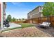 Private backyard with a lawn, a rock garden, patio space, and relaxing swing at 23593 E Chenango Pl, Aurora, CO 80016