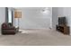 Expansive carpeted basement with neutral walls, leather couch, and entertainment center, perfect for relaxation at 23593 E Chenango Pl, Aurora, CO 80016