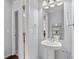 This bathroom features a pedestal sink, mirror, and storage shelf at 23593 E Chenango Pl, Aurora, CO 80016