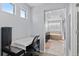Bright bathroom area with desk and doorway to bathroom with tub and double vanity sinks at 23593 E Chenango Pl, Aurora, CO 80016