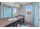 Bathroom featuring a double vanity sink with large mirror and view to the outside at 23593 E Chenango Pl, Aurora, CO 80016
