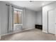 Bright bedroom with natural light from the large window, closet, and neutral colors at 23593 E Chenango Pl, Aurora, CO 80016