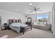 Spacious bedroom with large window, couch and a bed with a decorative bench at 23593 E Chenango Pl, Aurora, CO 80016