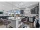 Modern kitchen with gray cabinets, stainless steel appliances, and granite countertop island and pendant lighting at 23593 E Chenango Pl, Aurora, CO 80016
