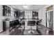 Modern kitchen with dark cabinets, a large island, and hardwood floors at 23593 E Chenango Pl, Aurora, CO 80016