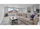 Open concept living room featuring sofa, coffee table, partition curtains, and carpet floors at 23593 E Chenango Pl, Aurora, CO 80016