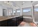 Bright main bathroom with dual sinks, soaking tub and walk-in shower at 23593 E Chenango Pl, Aurora, CO 80016