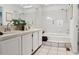 Bright bathroom showcasing a double vanity and tiled bathtub with shower for a serene experience at 1390 S Idalia St # 39F, Aurora, CO 80017