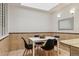 Bright dining area featuring a skylight, tiled accent wall, and a modern table set for four at 1390 S Idalia St # 39F, Aurora, CO 80017